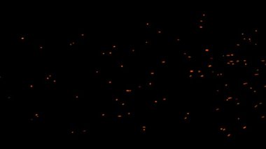 Gece gökyüzündeki büyük ateşten yanan kırmızı kıvılcımlar yükseliyor. Ateş, ışık ve yaşam temasının güzel soyut arkaplanı.