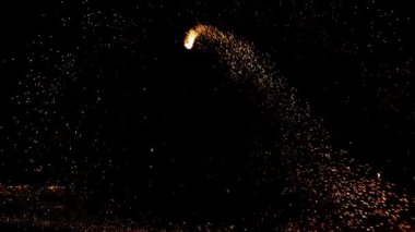 Gece gökyüzündeki büyük ateşten yanan kırmızı kıvılcımlar yükseliyor. Ateş, ışık ve yaşam temasının güzel soyut arkaplanı.