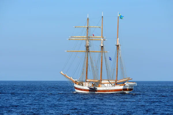 Старый исторический высокий корабль с белыми парусами в голубом море — стоковое фото