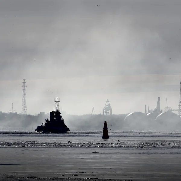 Siluetas de buques de carga y edificios portuarios en niebla —  Fotos de Stock