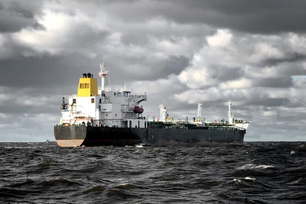 Vrachtschip zeilen in stormachtige weer in de buurt van haven van riga — Stockfoto