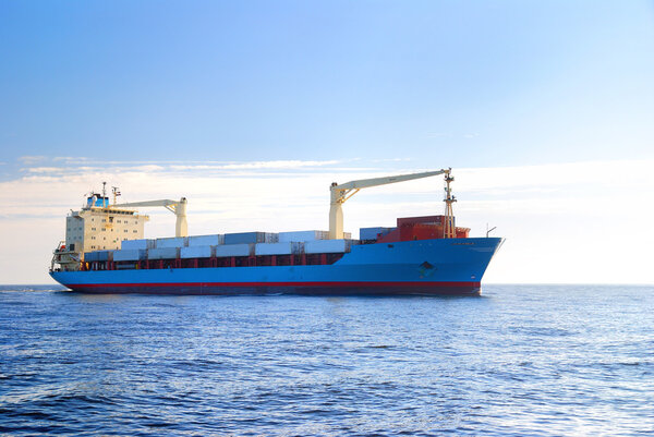 cargo container ship sailing in still water