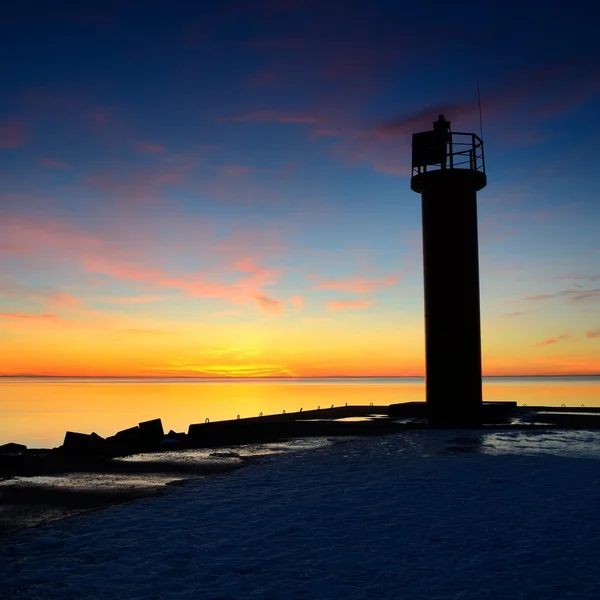 Lighthouse in the sea at the colorful sunset — Stock Photo, Image