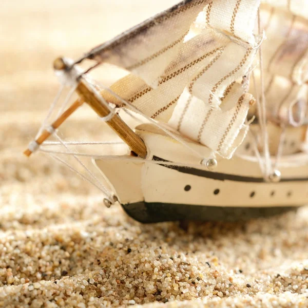 Wooden sail ship toy model in the sea sand close-up — Stock Photo, Image