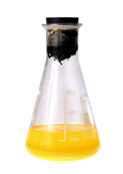 Laboratory flask with yellow liquid — Stock Photo, Image