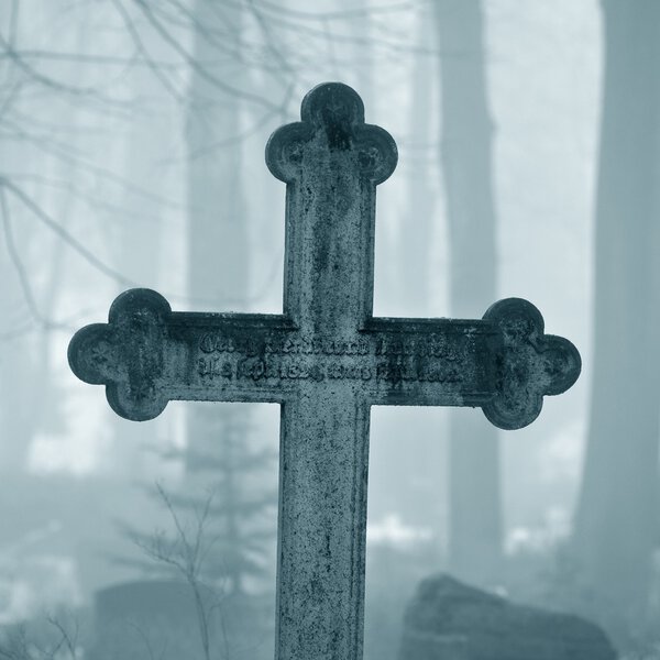 Cross in fog at the cemetery