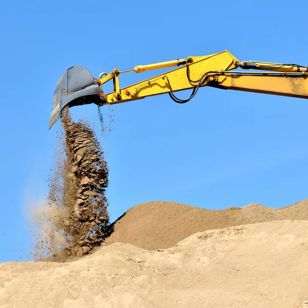 New yellow excavator working on sand dunes — Stock Photo, Image