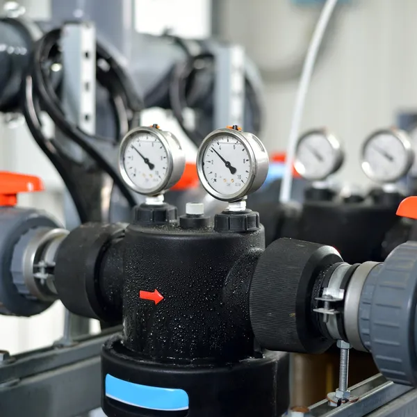 Industrial barometers and water pipes in boiler room — Stock Photo, Image