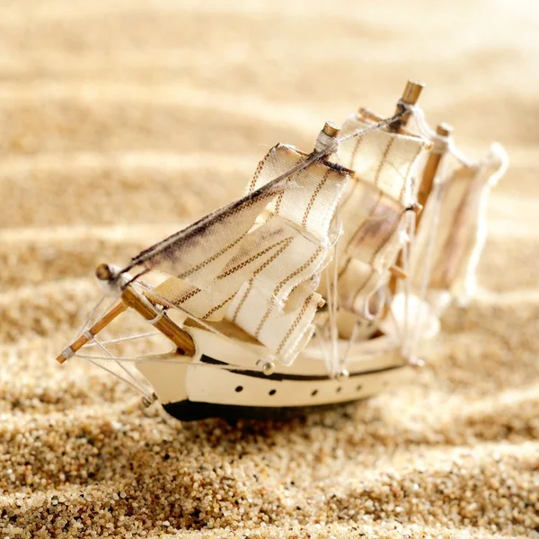 Wooden sail ship toy model in the sea sand close-up — Stock Photo, Image