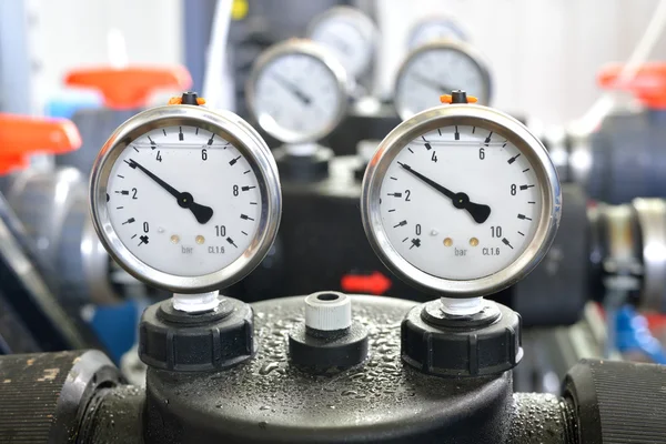 Industrial barometers and water pipes in boiler room — Stock Photo, Image