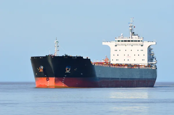 Cargo ship sailing in still water Stock Image