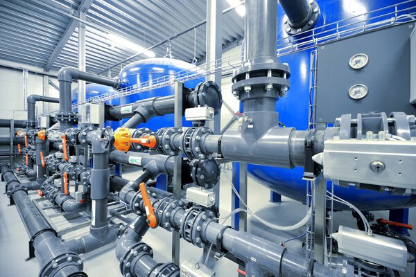 New plastic pipes and colorful equipment in industrial boiler room