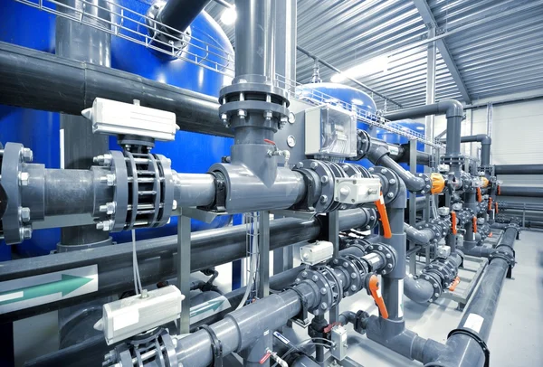 New plastic pipes and colorful equipment in industrial boiler room. Industry, technology, water treatment, chemistry, environment, heating, work safety. Panoramic view — Stock Photo, Image