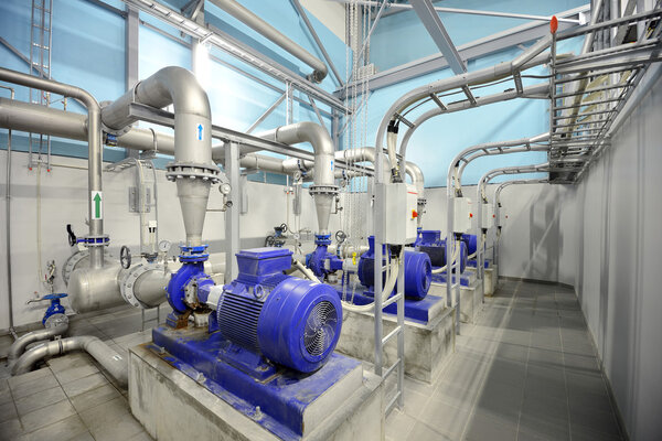 new shiny pipes and large pumps in industrial boiler room