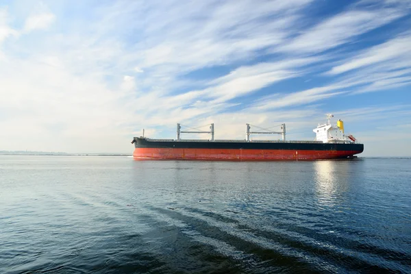 Large cargo ship sailing in still water Royalty Free Stock Photos