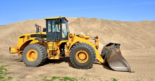 Bulldozer working in sand dunes — Stock Photo, Image