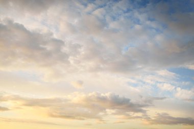Açık mavi gökyüzü. Pembe ve altın rengi sirrus ve kümülüs bulutları fırtına üstüne, yumuşak güneş ışığı. Dramatik gün batımı bulutları. Meteoroloji, cennet, barış, grafik kaynakları, pitoresk panoramik manzara