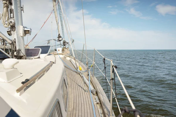 Herreshoff designed old classic yacht sailing in an open sea. Wooden teak deck. View to the mast and sails. Ketch sailboat. North American boat building traditions. Cruise, vacations, regatta, sport