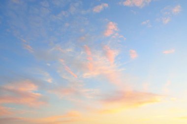 Açık mavi gökyüzü. Pembe parlayan, altın sirrus ve kümülüs bulutları fırtına üstüne, yumuşak güneş ışığı. Gün batımı bulutları. Meteoroloji, gece yarısı güneşi, cennet, huzur, grafik kaynakları, resimli panoramik manzara