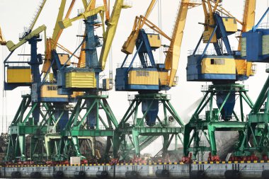 Riga, Letonya 'daki modern kömür terminali. Vinçler yakın plan. Baltık Denizi. Nakliye, lojistik, küresel iletişim, ekonomi, iş, endüstri, tedarik, özel ekipman. Şehir manzarası