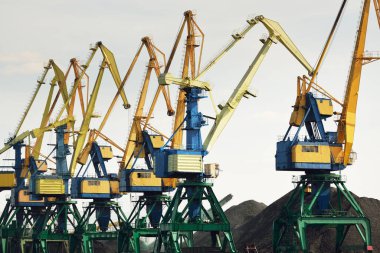 Riga, Letonya 'daki modern kömür terminali. Vinçler yakın plan. Baltık Denizi. Nakliye, lojistik, küresel iletişim, ekonomi, iş, endüstri, tedarik, özel ekipman. Şehir manzarası