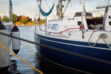 Açık bir yaz gününde yat limanındaki bir rıhtıma demirlemiş bir yelkenli canlı. Kira, ulaşım, dinlenme, tatil, boş zaman aktivitesi, spor, gezi, yaşam tarzı için özel bir gemi.
