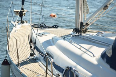 Limandaki bir rıhtıma demirlenmiş modern bir yat. Tahta meşe güvertesi, direği ve yelkenleri yukarıdan görüyor. Akdeniz 'de. Kiralık, gezici, eğlence, eğlence, eğlence, spor, yelkenli yarışı için özel bir gemi.