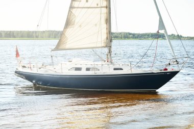 Kumlu kıyıya demirli mavi şalopalı yat (plaj). İsveç 'te, Avrupa' da. Doğa, yaz tatilleri, eğlence, gezi, spor, ulaşım, kiralık özel gemi.