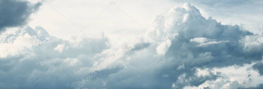 Clear blue sky with glowing clouds after storm at sunset. Soft sunlight. Dramatic cloudscape. Concept art, meteorology, heaven, peace, graphic resources, picturesque panoramic scenery
