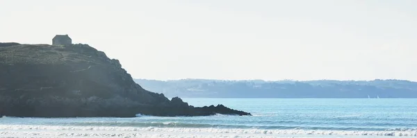 崖の上の孤独な伝統的な家 ドゥアルネネス湾の砂浜の海岸からの眺め 真っ青な空 波と水が飛び散った フランスのブルターニュ 旅行先 観光テーマ — ストック写真