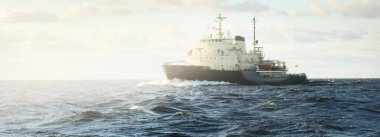 Sovyet buzkıranı dramatik günbatımı bulutları altında açık denizde. Yük taşımacılığı, küresel iletişim ve güvenlik, yakıt ve güç üretimi, sanayi, lojistik, araştırma, keşif