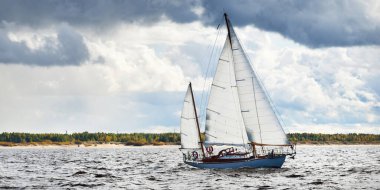 Eski pahalı, ahşap yelkenli (Ywl) yakın çekim, fırtınadan önce dramatik gökyüzü altında yelken. Yelkenli yat yarışı. Destansı bulut manzarası. Kiel, Kuzey Almanya