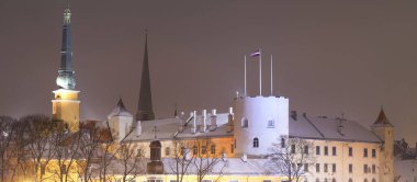 Panoramic aerial view of the illuminated snow-covered Riga old town, Latvia. Christmas vacations, travel guide, sightseeing theme
