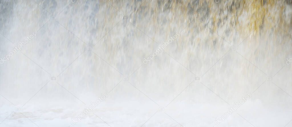Frozen Keila waterfall, icicles and water splashes close-up. Winter in Estonia. Abstract natural pattern, graphic resources, climate change and global warming concept, environmental conservation
