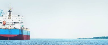 Large cargo ship loading in port terminal. Panoramic view. Freight transportation, nautical vessel, global communications, logistics, shipping, delivery, industry, commerce, economy