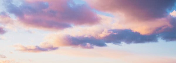 Clear blue sky with glowing pink and golden clouds after the storm. Dramatic sunset cloudscape. Concept art, meteorology, heaven, hope, peace. Graphic resources, picturesque panoramic scenery