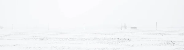 Pokryte Śniegiem Pole Linia Energetyczna Podczas Zamieci Koncepcja Krajobrazu Zimowego — Zdjęcie stockowe
