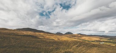Dağlar, karanlık fırtına gökyüzünün altında zirve yapar. Dramatik bulutlar. Jura Adası, Inner Hebrides, İskoçya, İngiltere. Atmosferik manzara. Panoramik görünüm