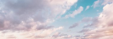 Açık mavi gökyüzü. Pembe ve altın rengi sirrus ve kümülüs bulutları fırtına üstüne, yumuşak güneş ışığı. Dramatik gün batımı bulutları. Meteoroloji, cennet, barış, grafik kaynakları, pitoresk panoramik manzara