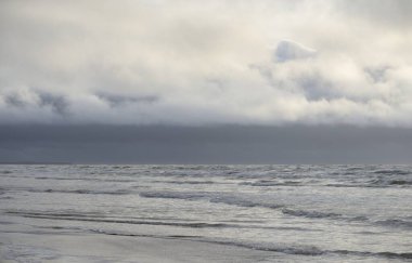 Fırtınadan sonra Baltık Denizi. Yumuşak günbatımı ışığı, çarpıcı parlayan bulutlar. Deniz manzarası, bulutlar, doğa. Panoramik manzara. Ekoloji, iklim değişikliği, hava durumu