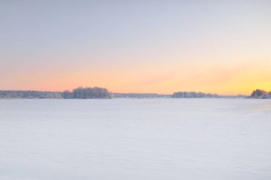 Gün doğumunda karla kaplı alanın (orman çayırı) atmosferik manzarası. Saf altın güneş ışığı. Kar tepeleri. Kış Harikalar Diyarı. Mevsimler, eko-turizm, Noel tatilleri, uzak yerler, off-road