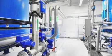 Large blue tanks in a industrial city water treatment boiler room. Wide angle perspective. Technology, chemistry, heating, work safety, supply, infrastructure