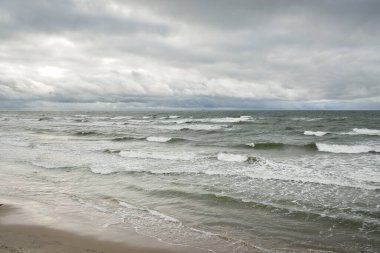 Fırtına sırasında Baltık Denizi. Dramatik gökyüzü, karanlık, parlak bulutlar. Dalgalar, su sıçramaları. Idyllic deniz manzarası. İklim değişikliği, doğa, kararsız hava, ekoloji