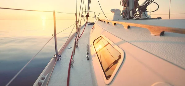 白いヨットは日没時に静かな水の中を航海する デッキから弓 マスト 帆への眺め 見事な雲景だ 水に関する考察 バルト海 ライフスタイル クルーズ レガッタ — ストック写真