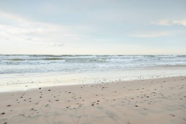 Gün batımında Baltık kıyısı. Açık günbatımı gökyüzü, parlayan bulutlar. Idyllic manzara. Doğa, tatiller, eğlence. Çevre turizmi. Panoramik görünüm
