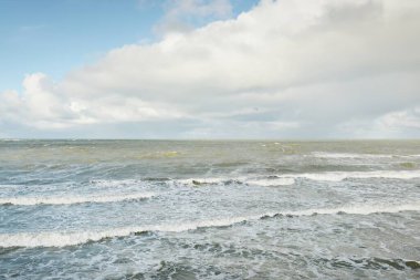 Fırtınadan sonra dramatik günbatımı bulutları altında Baltık Denizi. Dalgalar, su sıçratma. Destansı deniz manzarası. 40-50 deniz mili rüzgar gücü. Kasırga, fırtına, sert hava, meteoroloji, ekoloji, iklim değişikliği