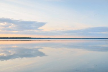 Forest lake (river) at sunset. Glowing clouds, symmetry reflections in a crystal clear water. Idyllic landscape. Picturesque panoramic scenery. Pure nature, ecology, ecological reserve, ecotourism