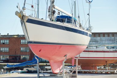45 ft cruising sailboat standing on land in a yacht marina. Transportation, nautical vessel, repair and service, sailing, sport, recreation. tourism, leisure activity concepts