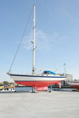 45 ft cruising sailboat standing on land in a yacht marina. Transportation, nautical vessel, repair and service, sailing, sport, recreation. tourism, leisure activity concepts
