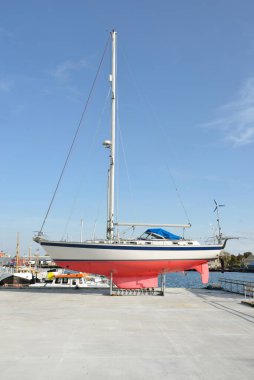 45 ft cruising sailboat standing on land in a yacht marina. Transportation, nautical vessel, repair and service, sailing, sport, recreation. tourism, leisure activity concepts